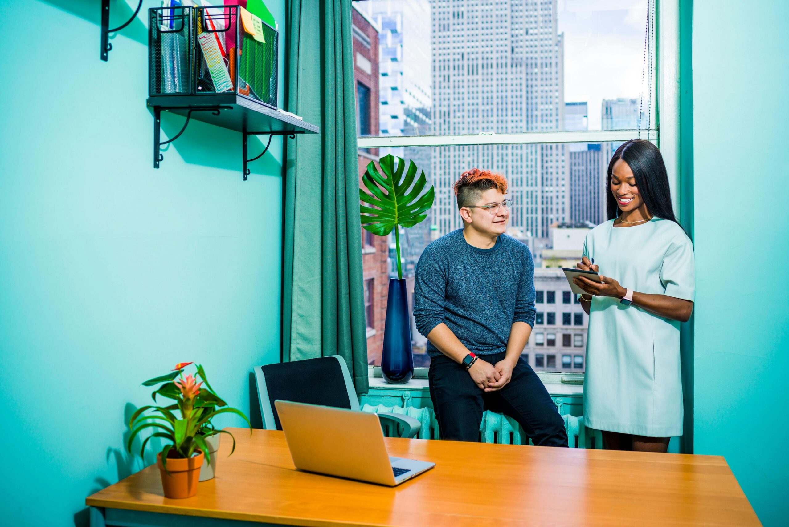 CompTIA Security+ Business meeting between two colleagues in a modern office with a city view.